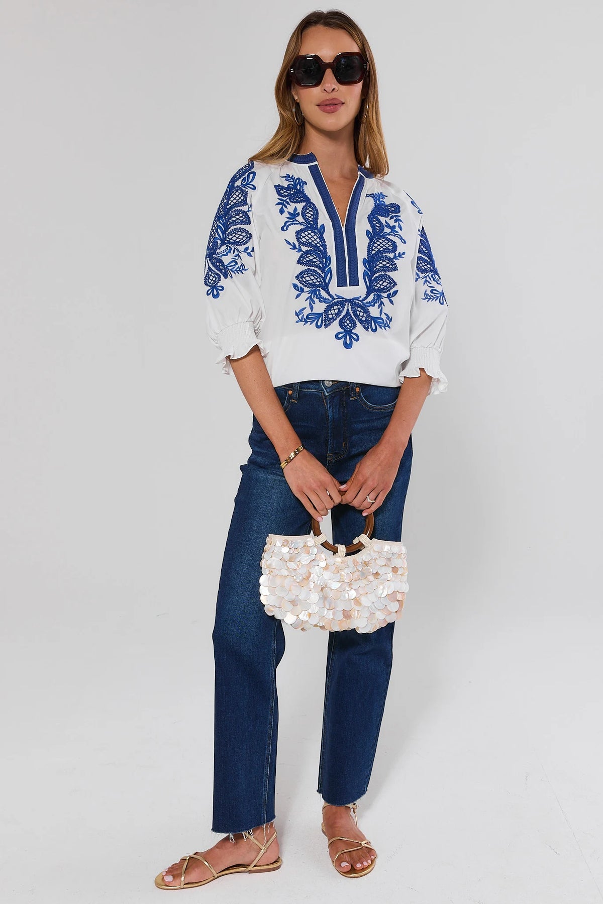 Iris White Embroidered Split Neck Top with jeans, sunglasses and sequin bag - Styled Vacation Look | Avara