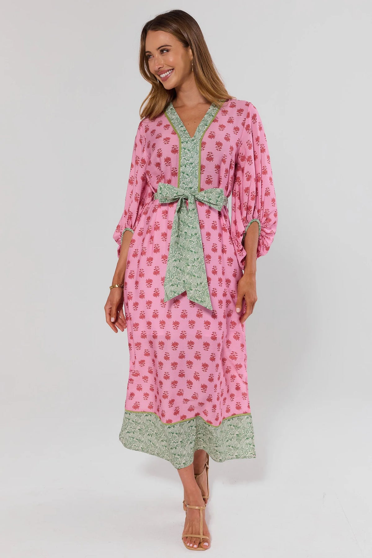 Tessa Pink Printed Tie Waist Midi Dress - Three-Quarter Front View, Green Border Hem and Strappy Sandals | Avara