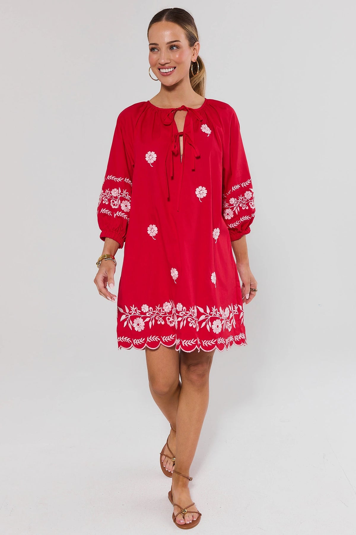 Tara Red Embroidered Short Dress, full-length front view, scalloped hem, styled with tan sandals | Avara