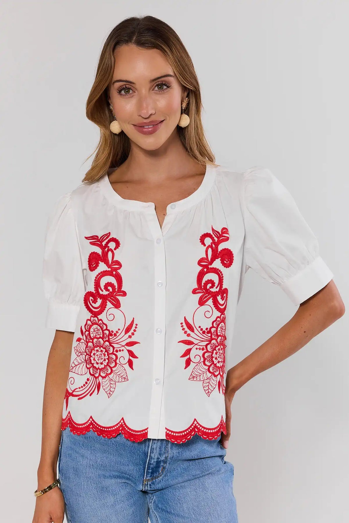 White Embroidered Button Up Top with red floral detail, puff sleeves, styled with denim - Front View | Avara