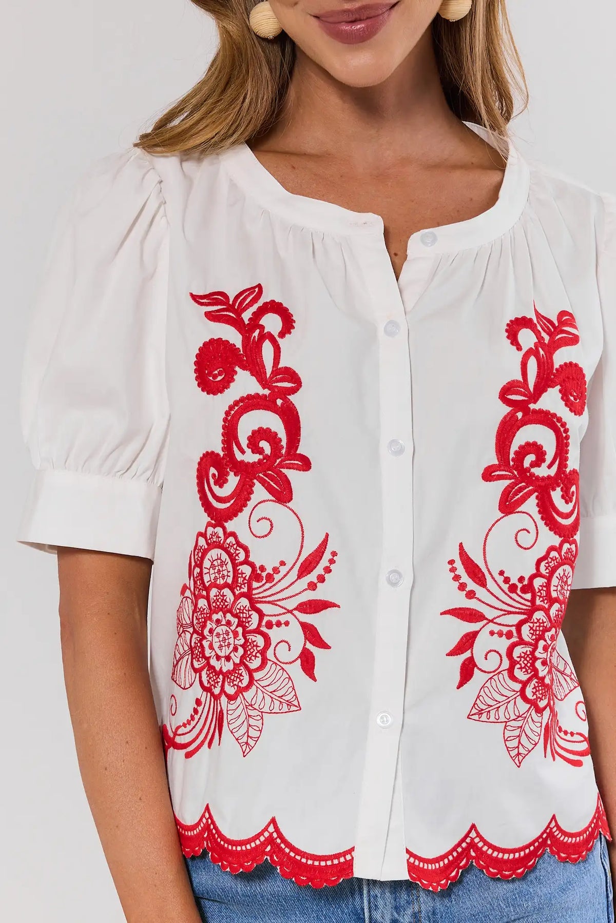 White Embroidered Button Up Top close-up showing red floral embroidery and scallop hem detail | Avara