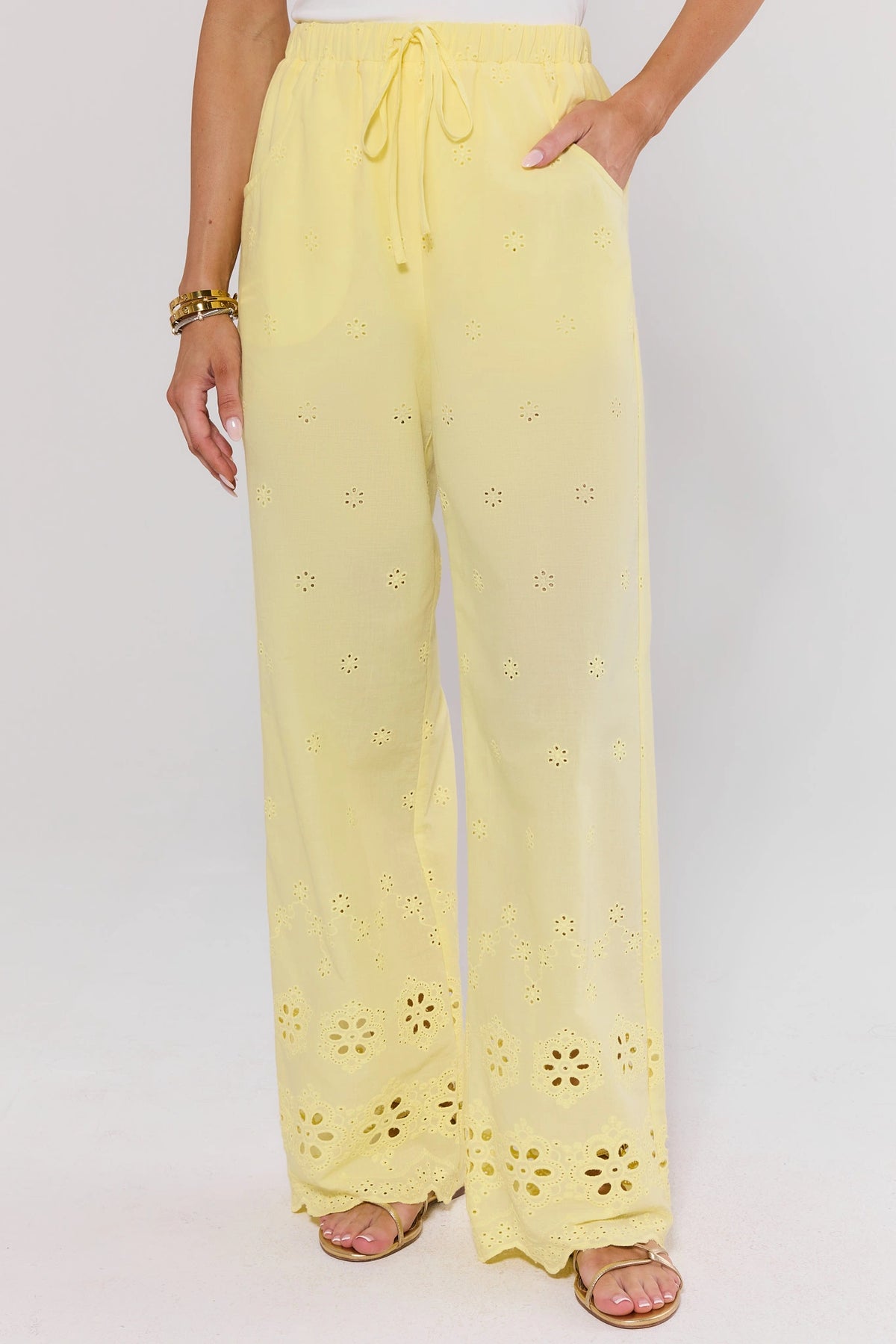 Yellow Eyelet Wide Leg Pants with floral cut-out hem detail and drawstring waist - Front On-Model | Avara