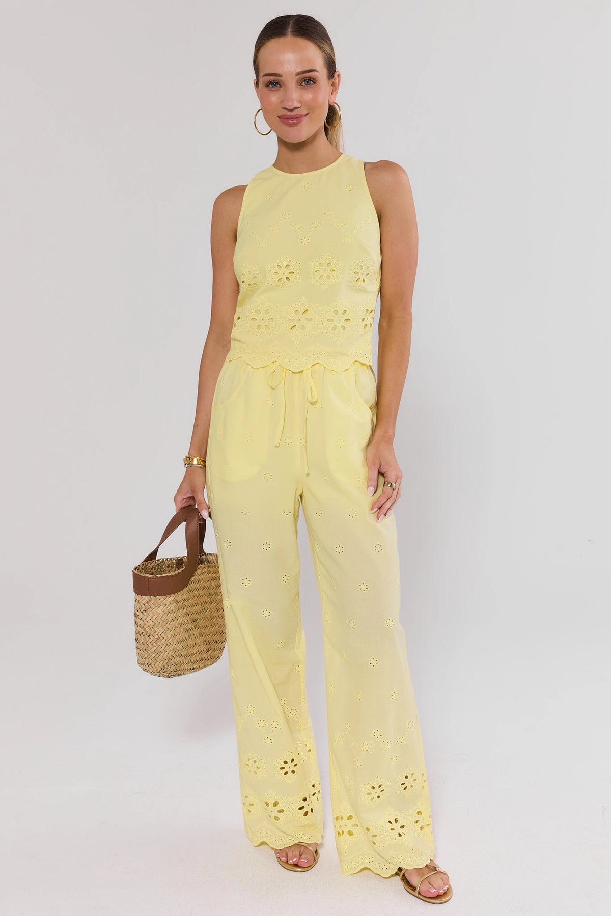 Yellow Eyelet Wide Leg Pants styled as matching set with eyelet top and straw bag - Full Look On-Model | Avara