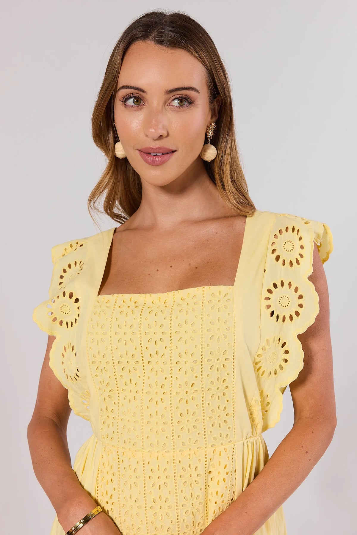 Yellow Eyelet Midi Dress - Front Close-Up of Square Neckline & Flutter Sleeve on Model | Avara