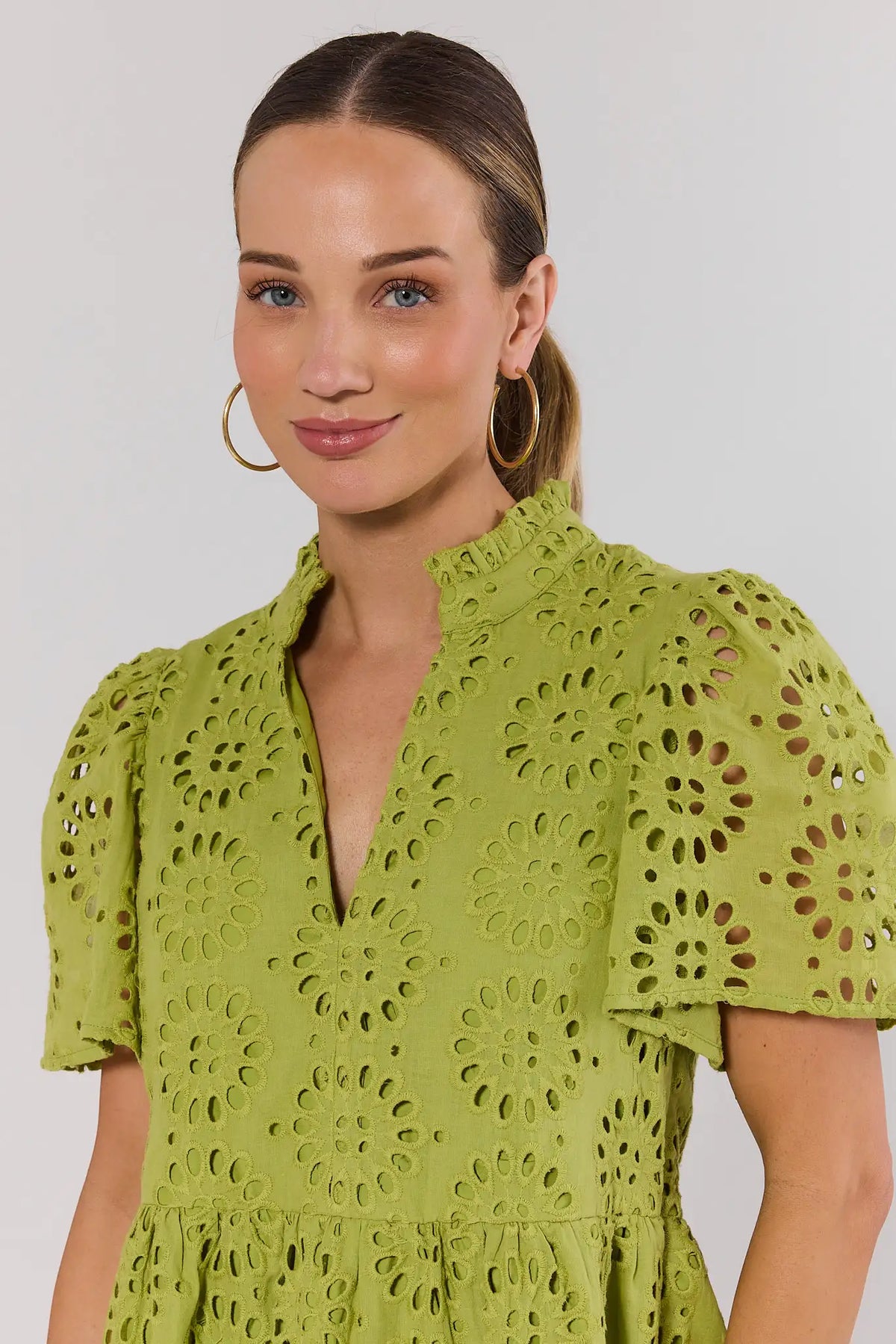 Green Eyelet Dress Close-Up Detail - Ruffle Mock Neck and Puff Sleeve | Avara