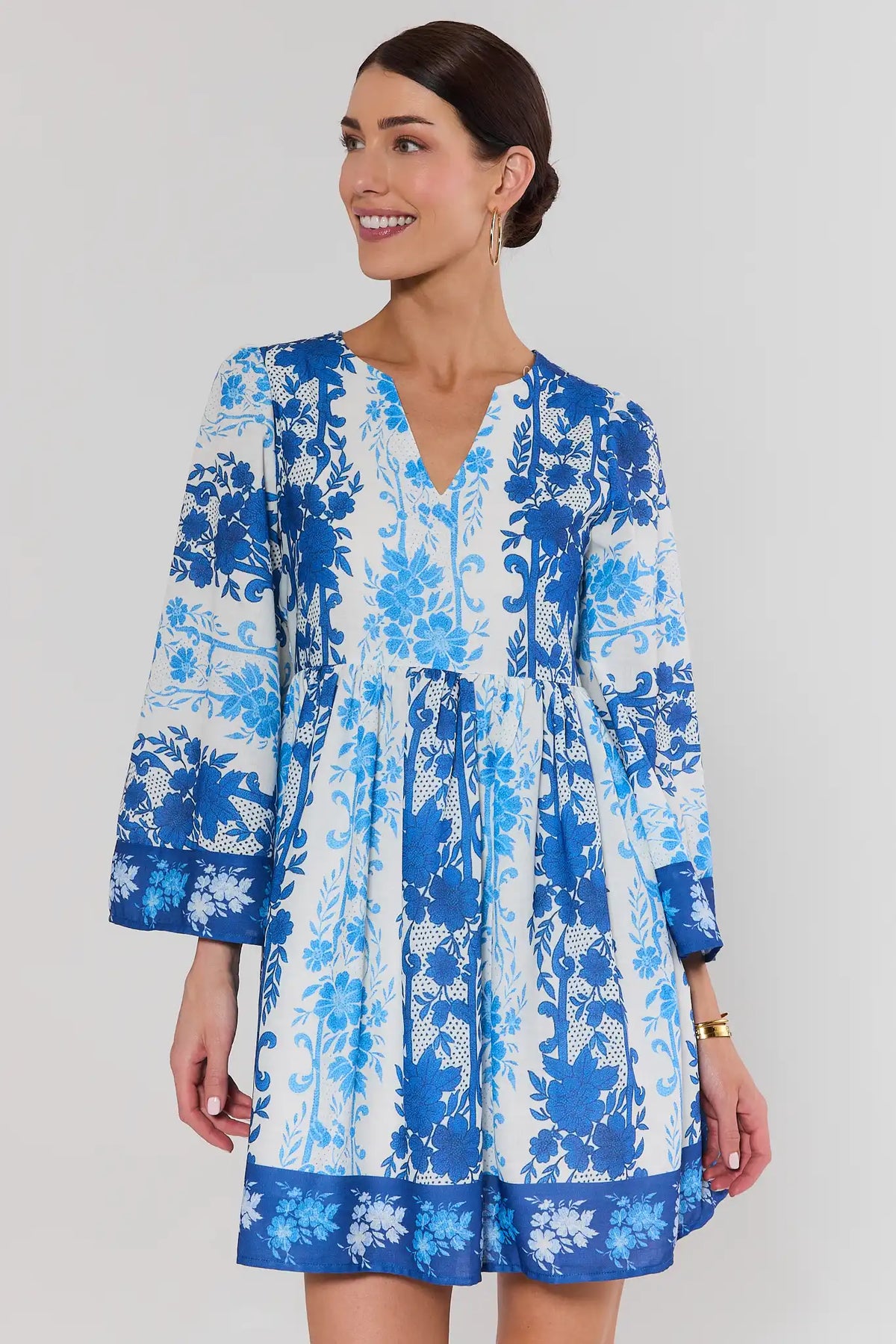 Blue Mixed Floral Print Short Dress with bell sleeves and V-neckline, front view on model | Avara