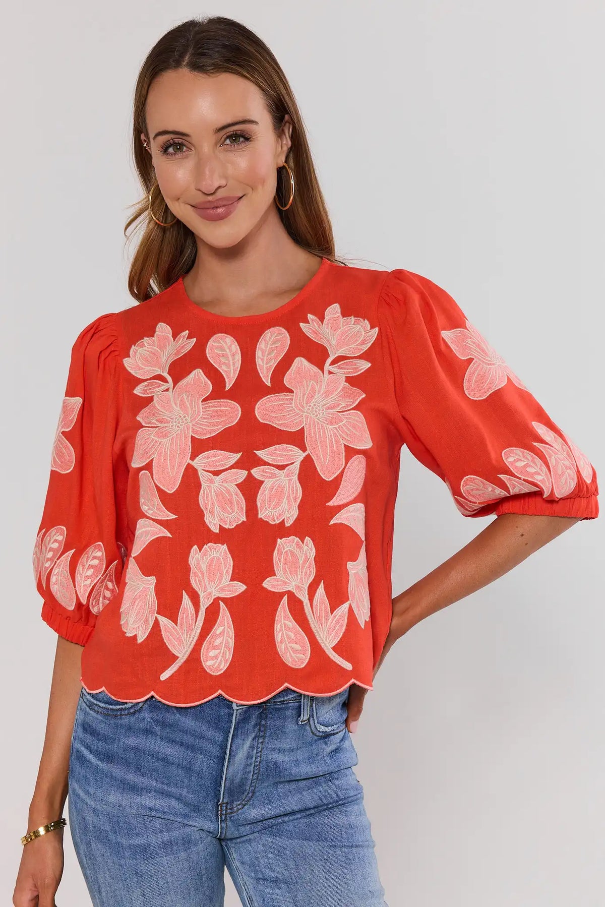 Orange floral applique top by THML with scallop hem, on model front view paired with blue jeans | Avara