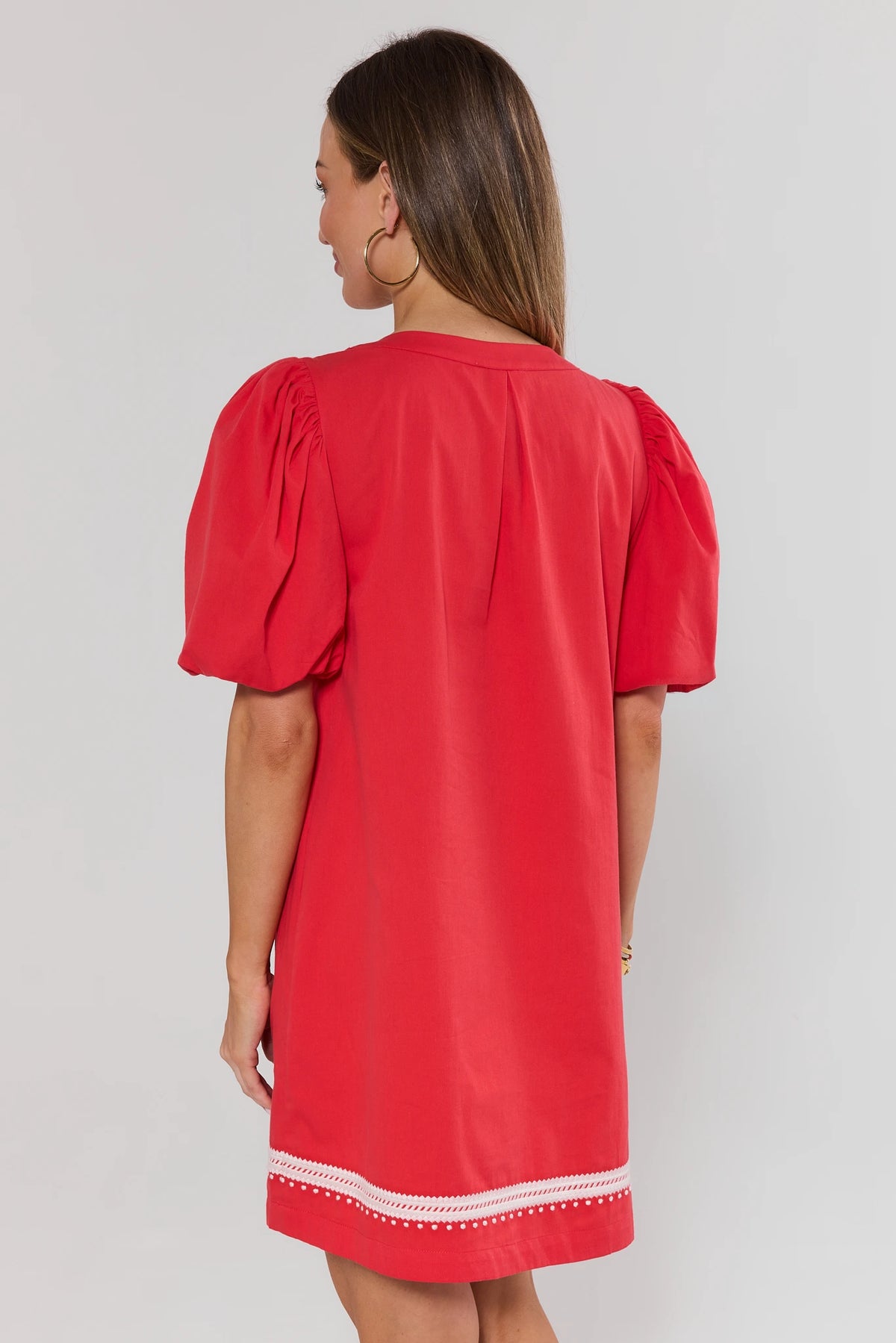 Roxanne Red Embroidered Short Dress back view showing puff sleeves and white embroidered hem trim | Avara