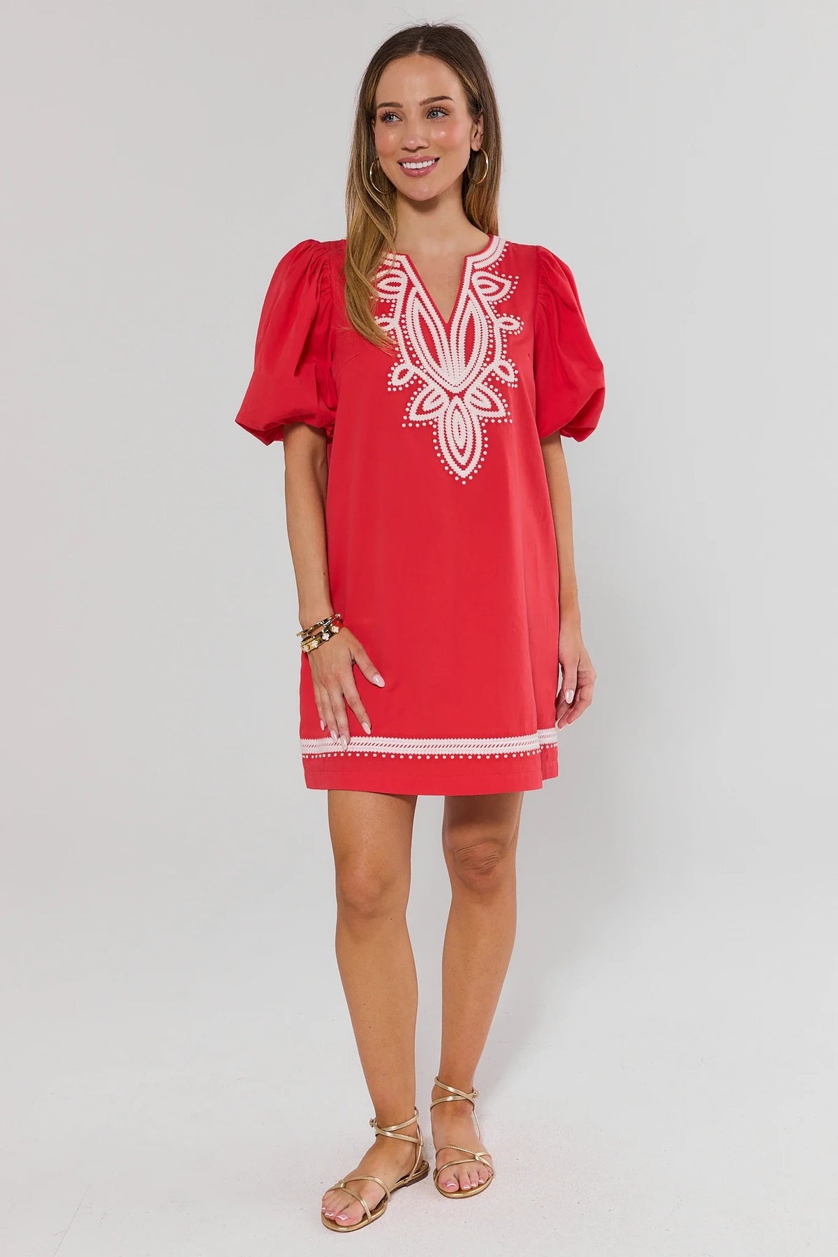 Roxanne Red Embroidered Short Dress three-quarter view showing puff sleeves and white trim hem | Avara