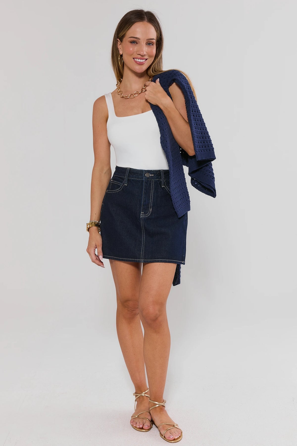 Mallory Dark Wash Denim Skirt full styled look with white tank and navy knit cardigan | Avara