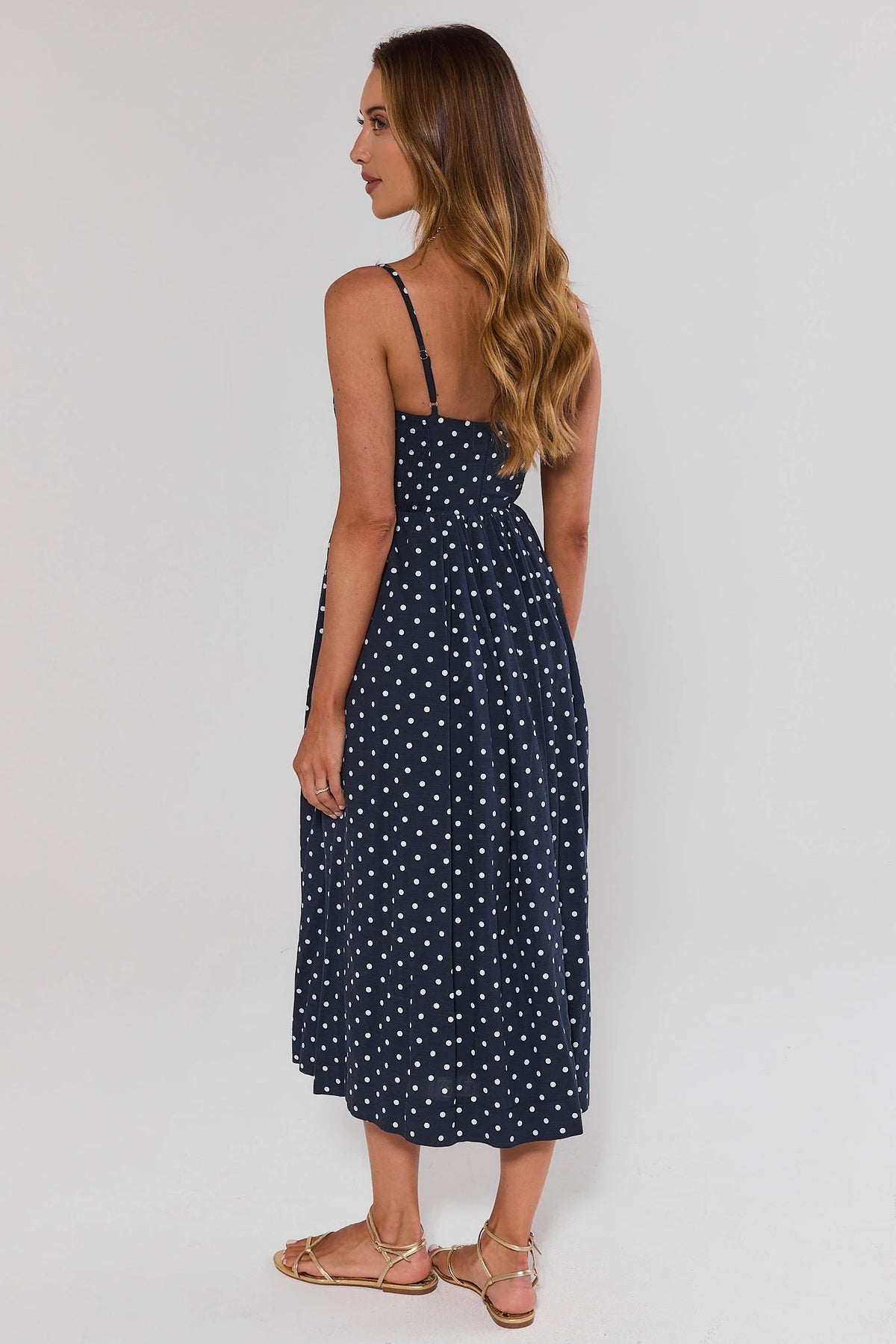 Navy polka dot midi dress with adjustable straps and gathered waist - Back View | Avara