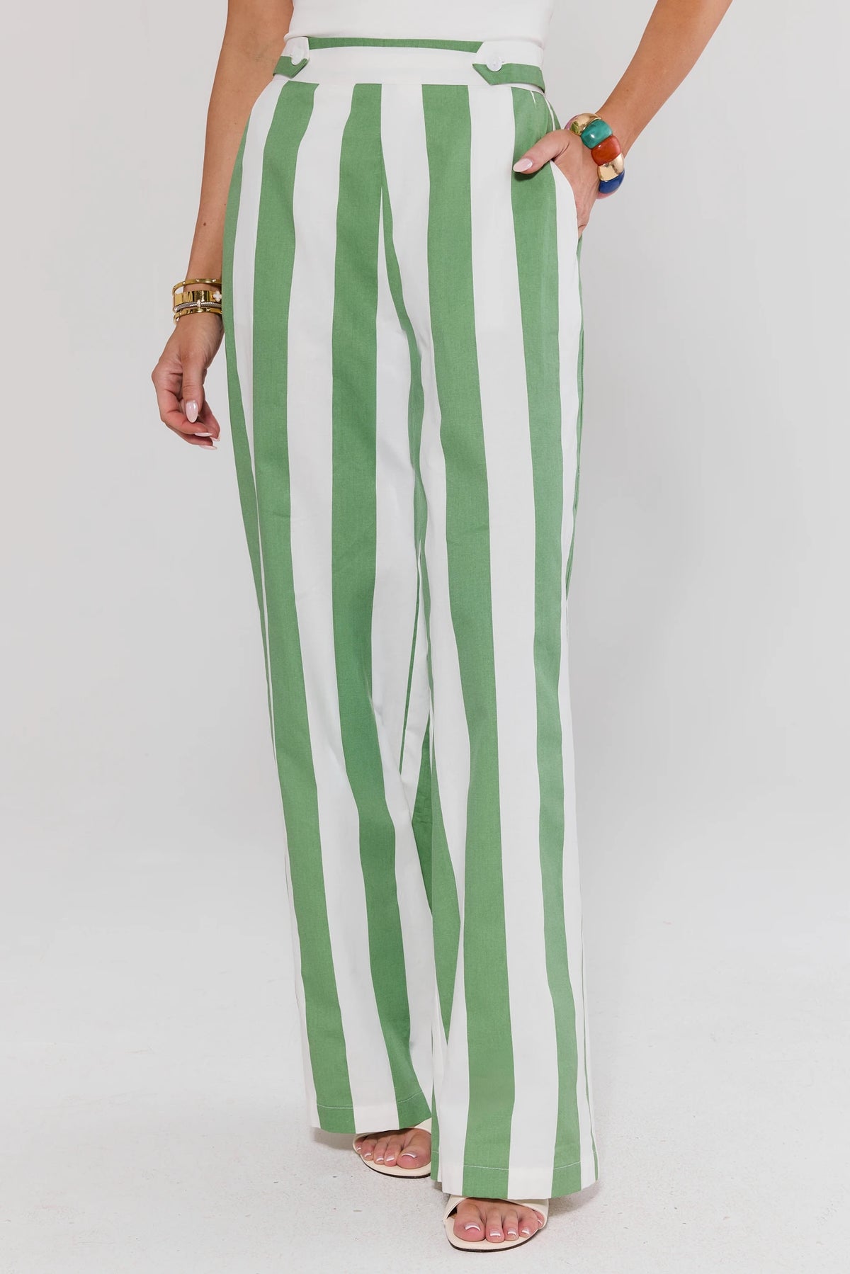 Green and white striped tailored wide leg pants on model, front view with side pocket | Avara