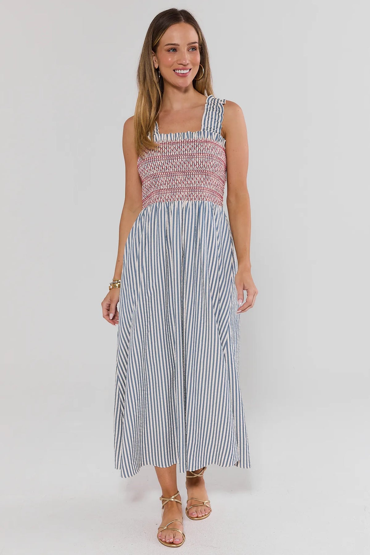 Teagan Smocked Midi Dress by THML in blue stripe seersucker with red contrast smocking - Full Front View On Model | Avara
