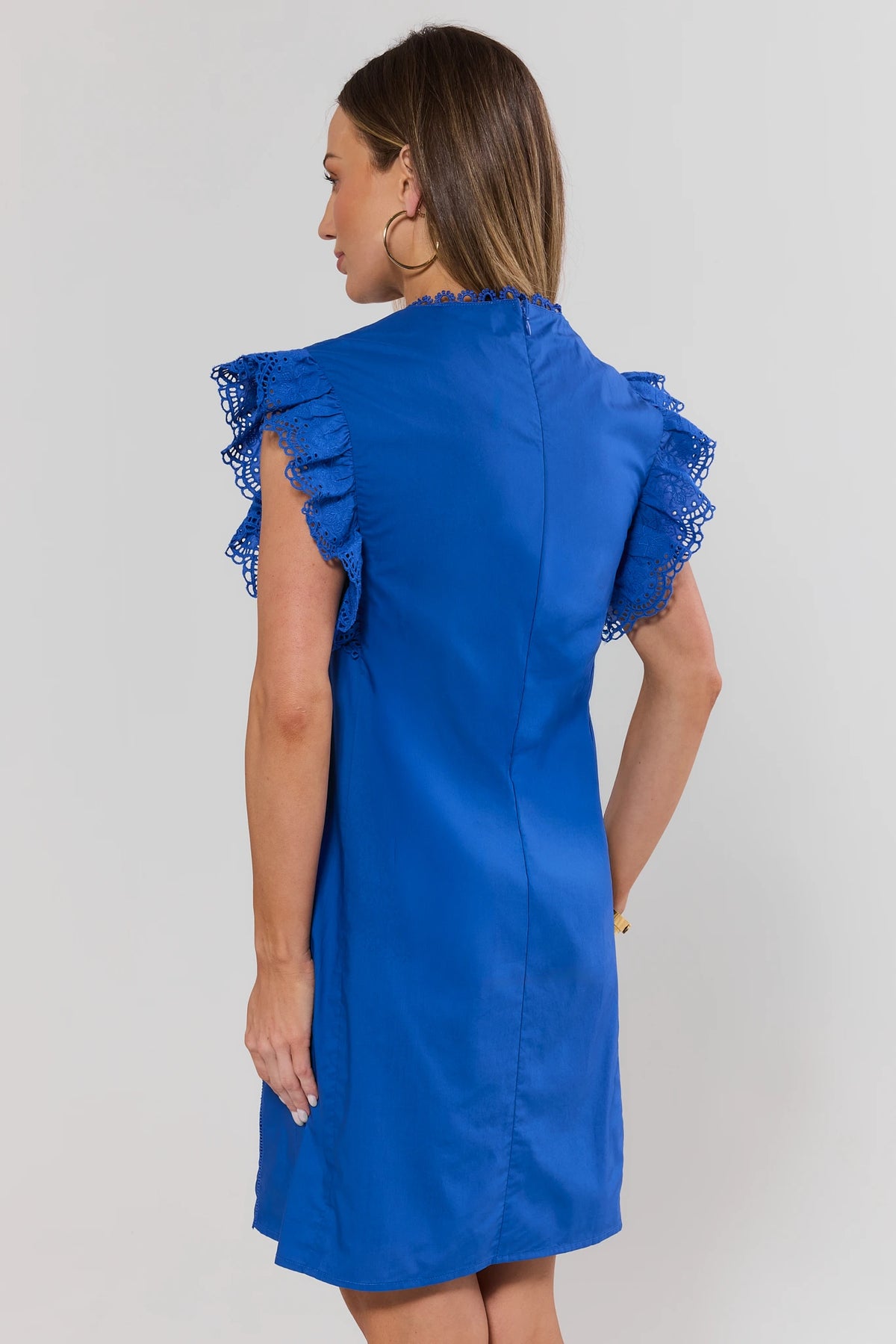 Blue flutter sleeve short dress showing back view with eyelet ruffle sleeve detail and center seam | Avara
