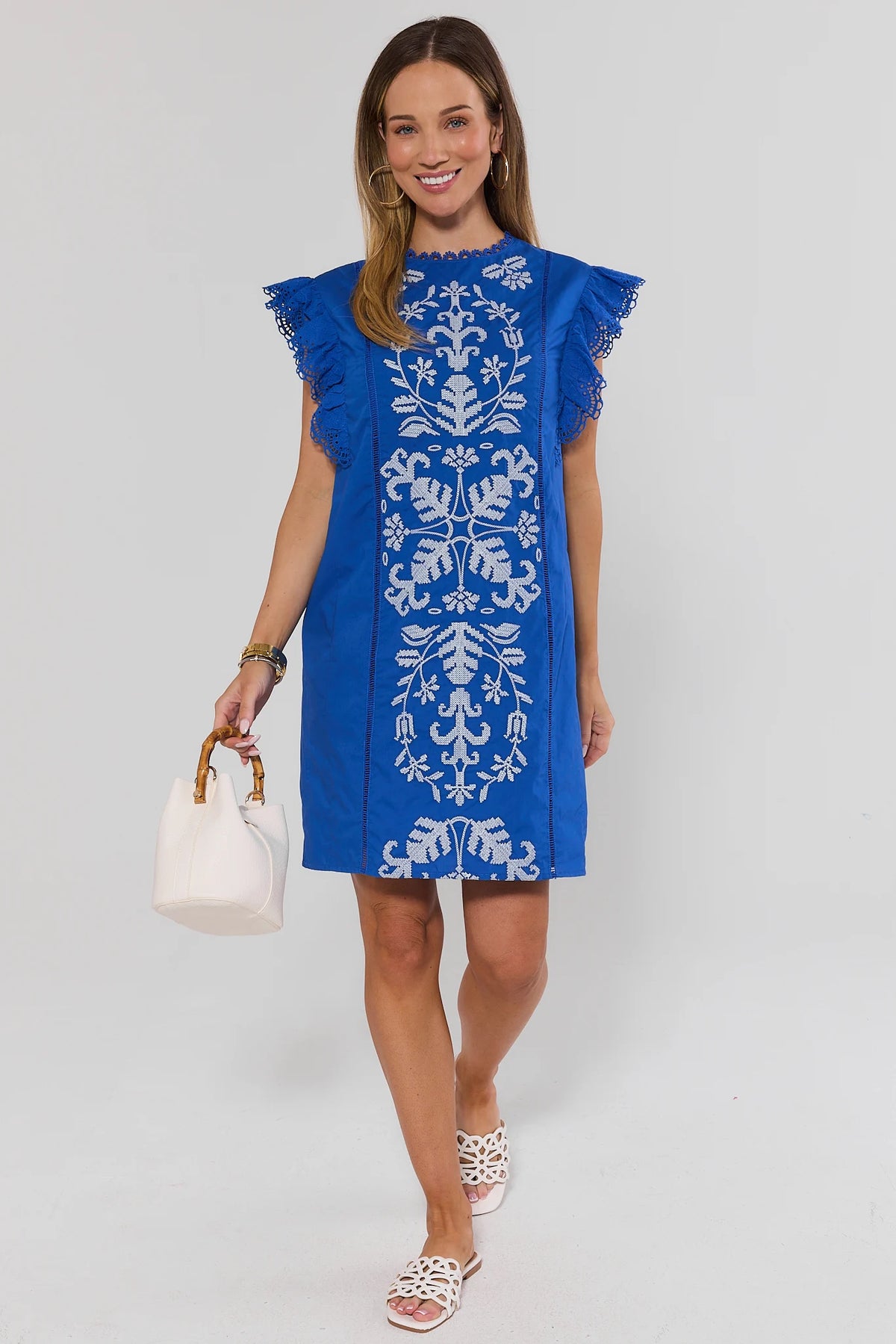 Blue embroidered flutter sleeve short dress styled with white sandals and bamboo bag - Full Length | Avara
