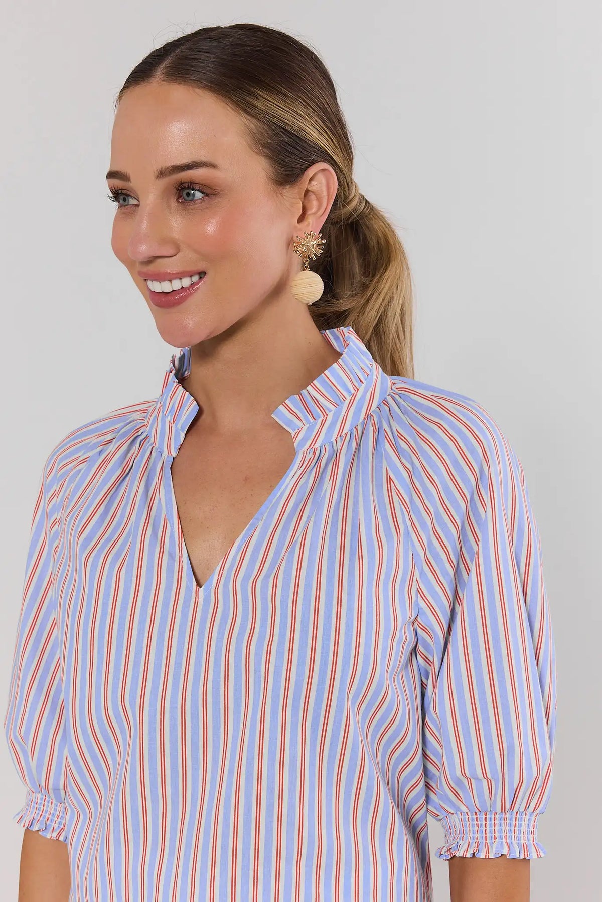 Close-up of Merrick Blue Striped Split Neck Top showing smocked cuffs and ruffle collar detail | Avara