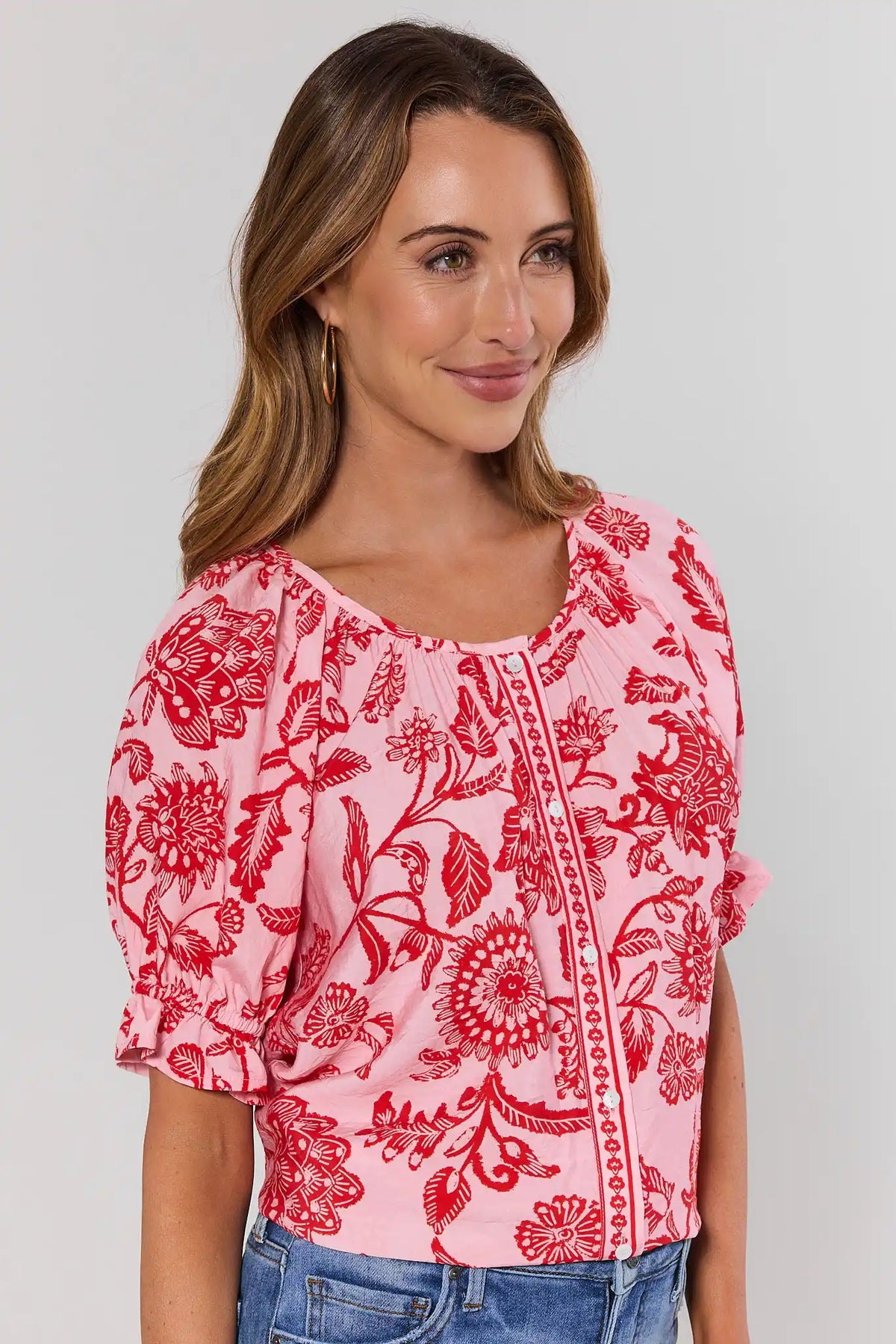 Pink Floral Button Up Top with red print and smocked cuffs - Side Angle View | Avara