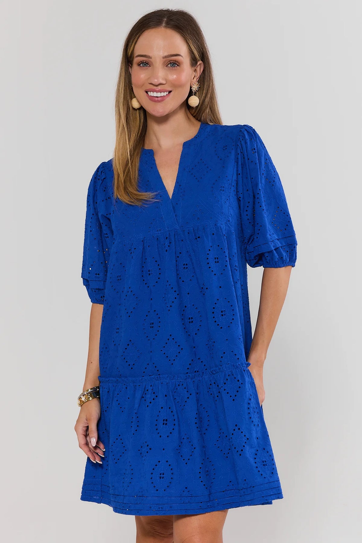 Woman wearing a blue dress with a white background