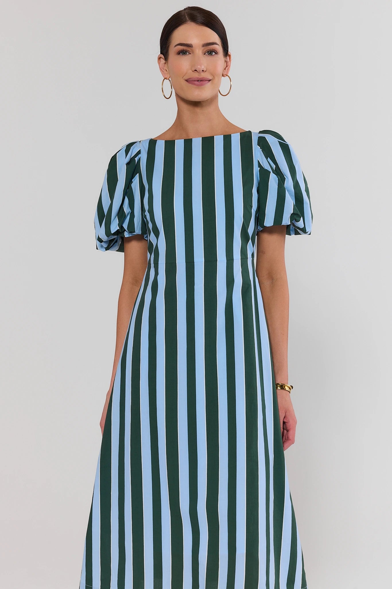 Blue and green striped puff sleeve midi dress on model, cropped front view on white background | Avara