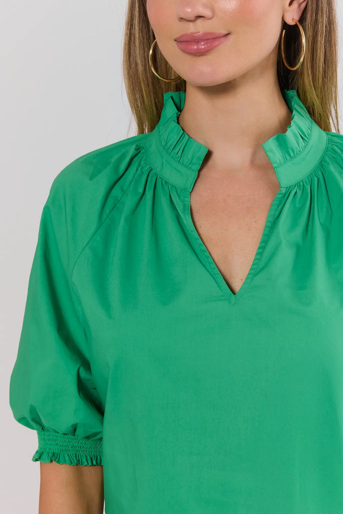 Merrick Green Split Neck Top close-up showing ruffle split neckline and smocked puff sleeve detail | Avara