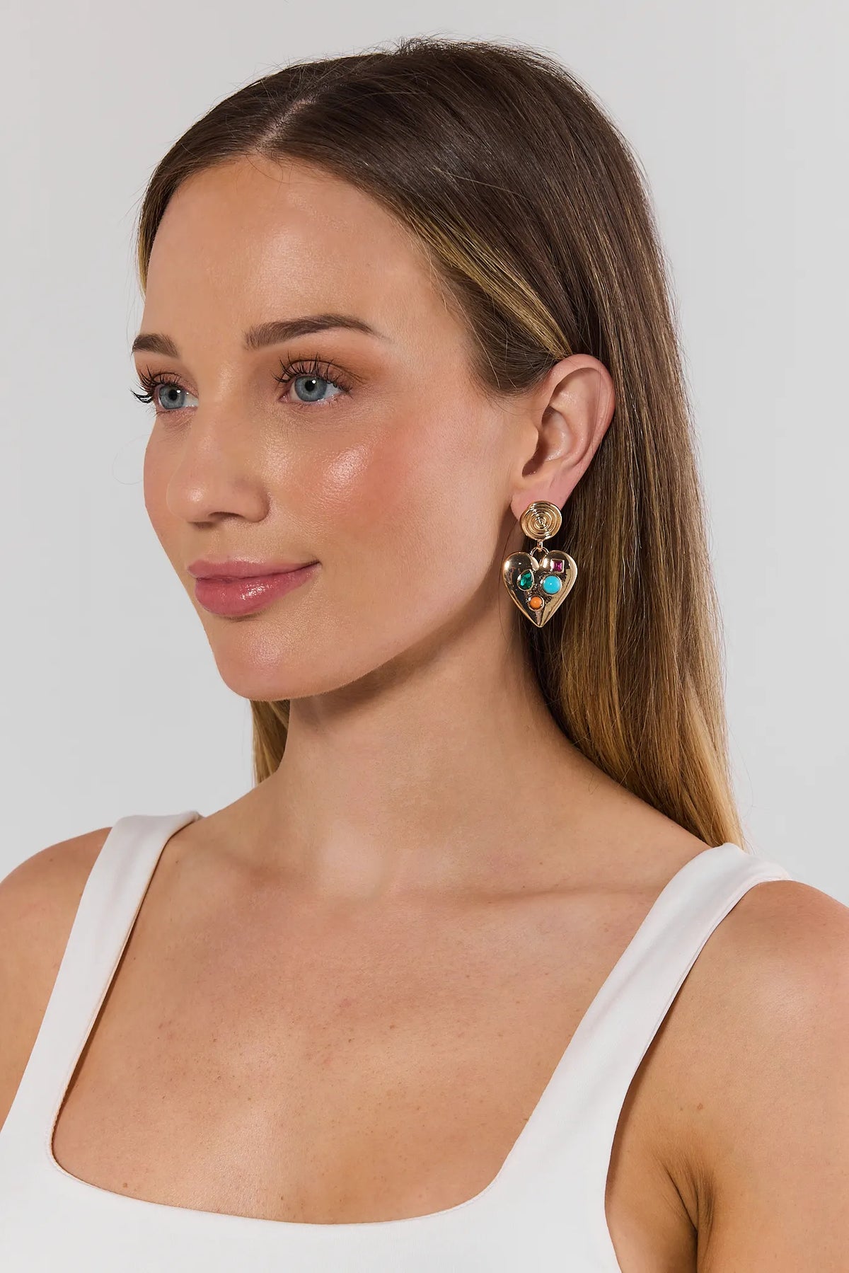 Gold Heart Gem Drop Earrings with multicolor gemstones worn on model - Side View | Avara
