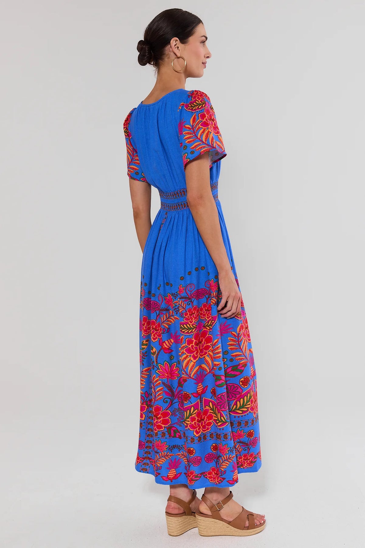 Blue floral maxi dress back view, smocked waist, flutter sleeves, full-length modest silhouette | Avara