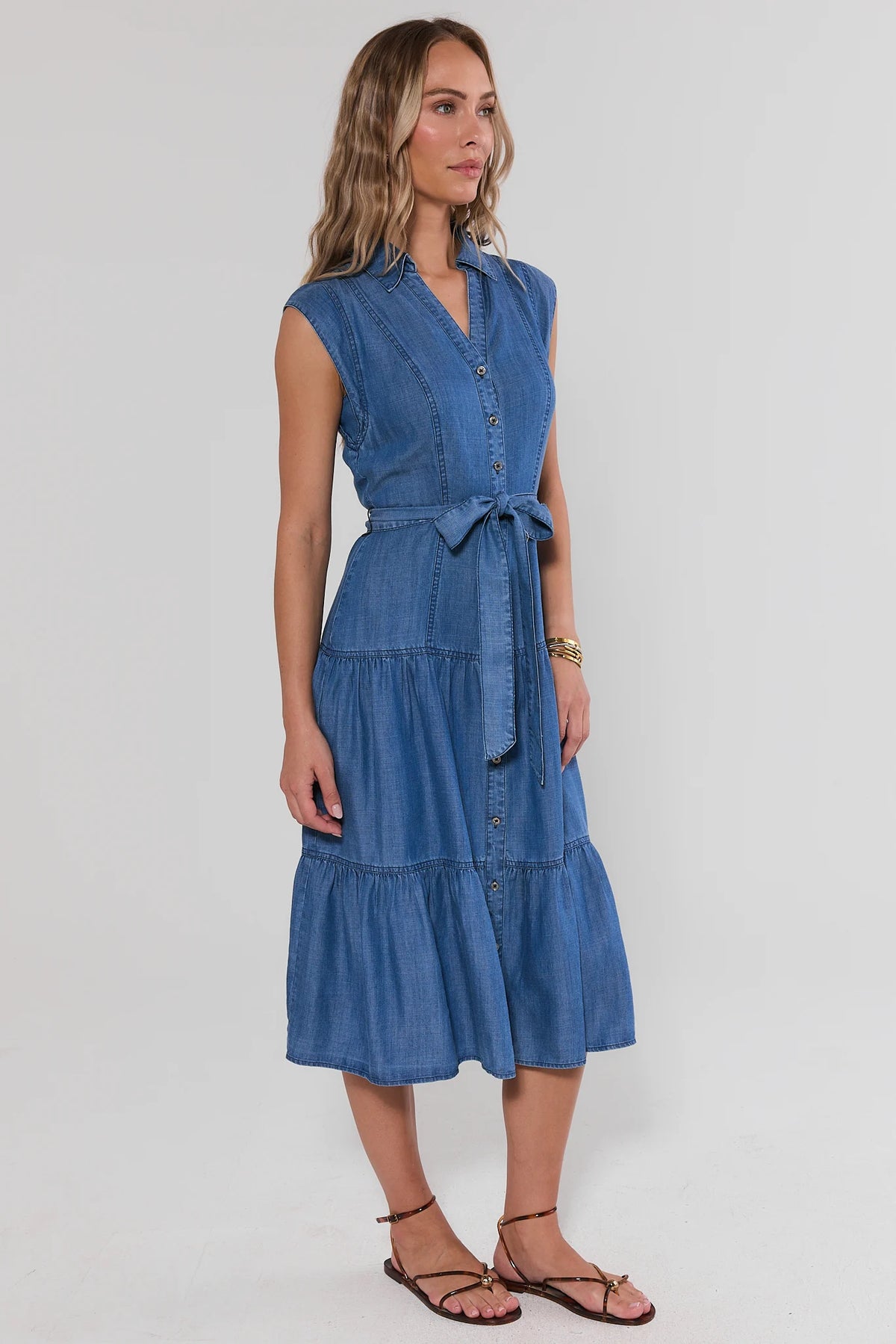 Nadine Chambray Midi Dress in blue - side view showing tiered skirt and belted waist | Avara