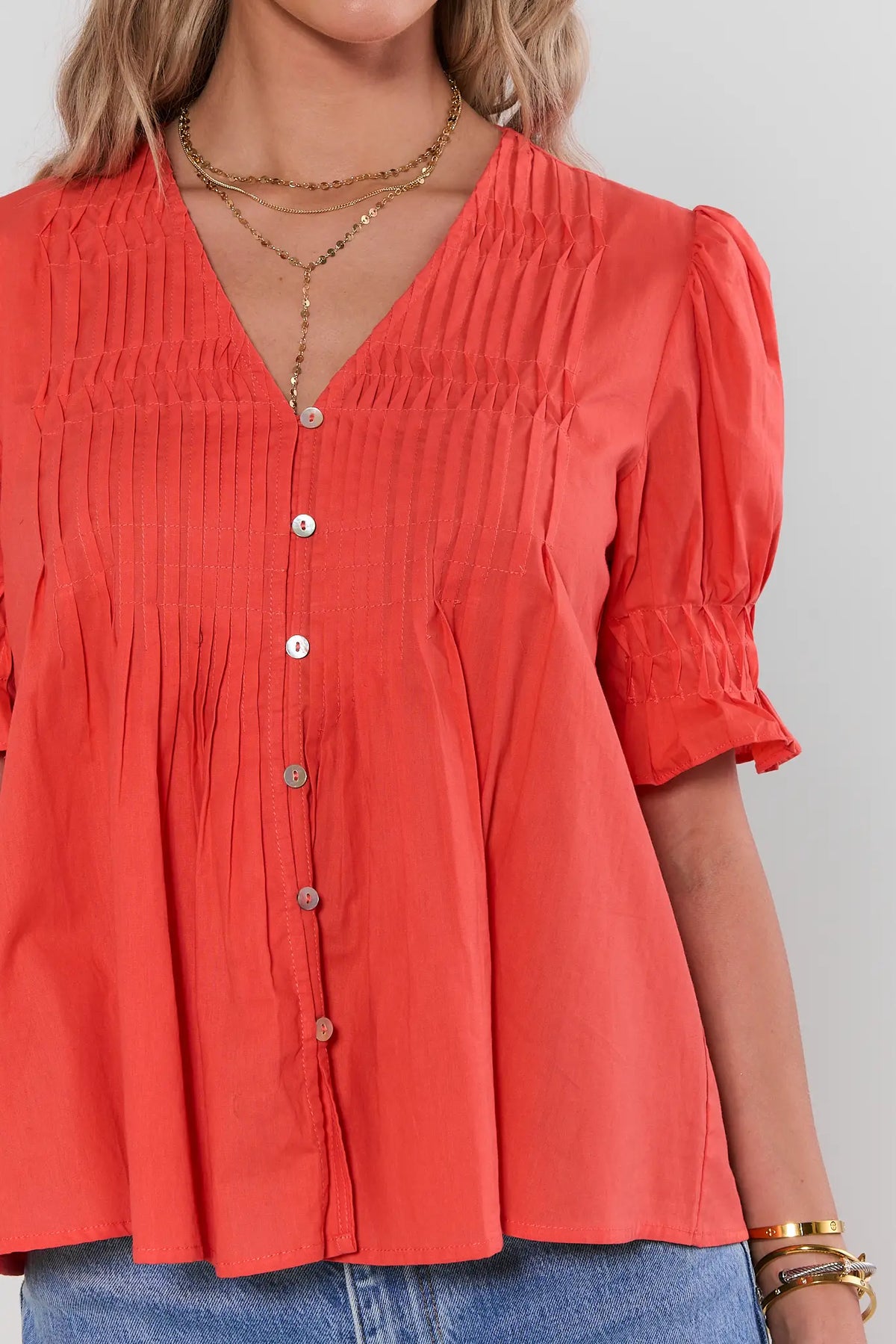 Orange pleated top pintuck & smocked ruffle sleeve close-up detail - Detail View | Avara
