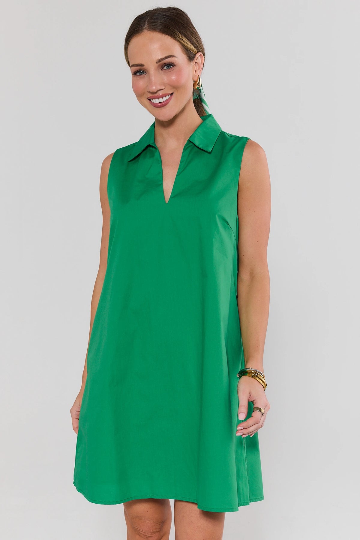 Woman wearing green sleeveless Ellen Short Dress with collar neckline, front view | Avara