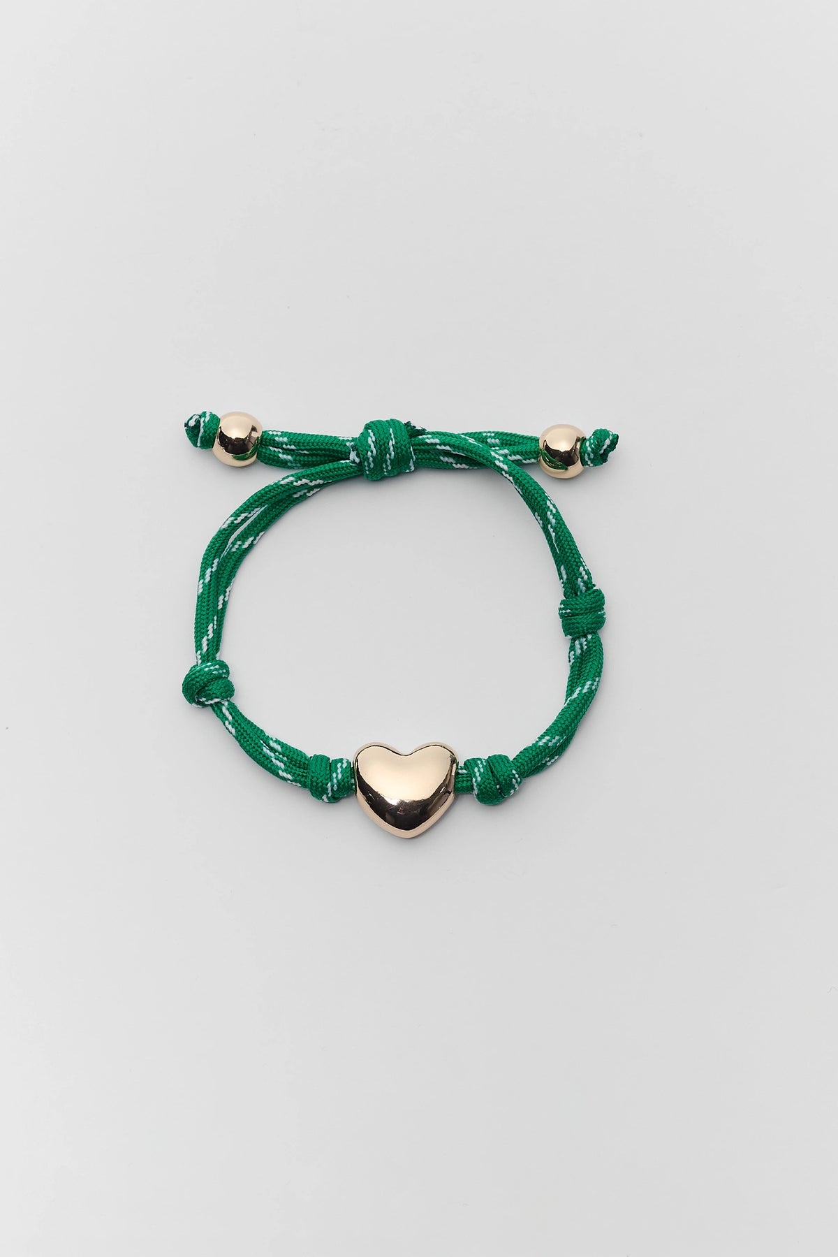 Green paracord heart charm bracelet with gold-tone heart bead - Flat Lay | Avara