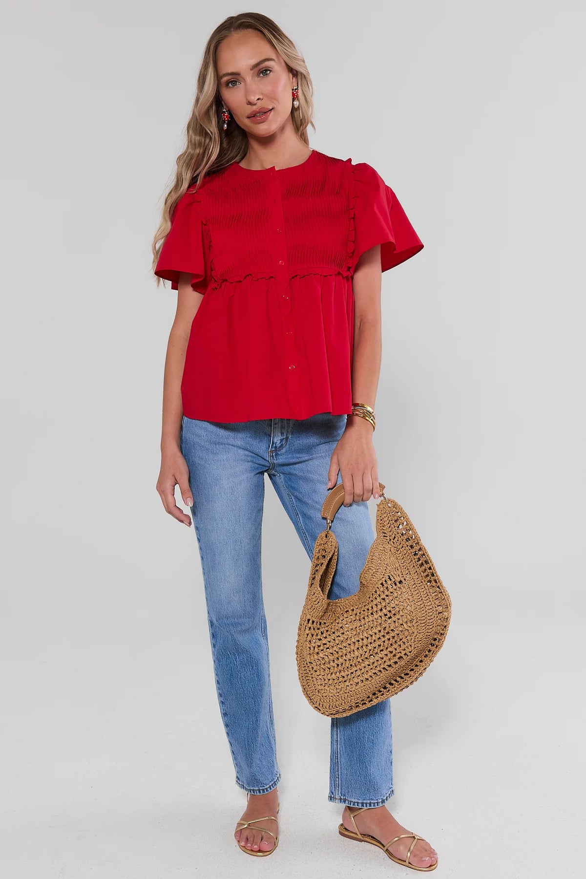 Red peplum top styled with blue jeans and woven straw bag, gold sandals - Full Length Styled Look | Avara
