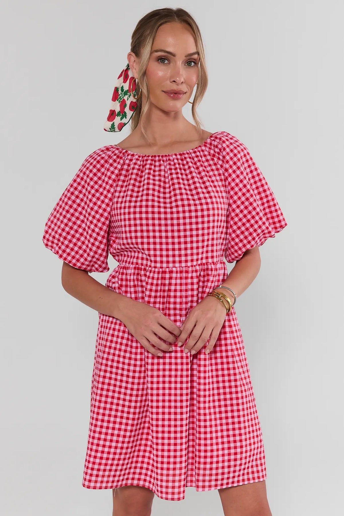 Red gingham puff sleeve short dress with boat neckline, front view on model | Avara