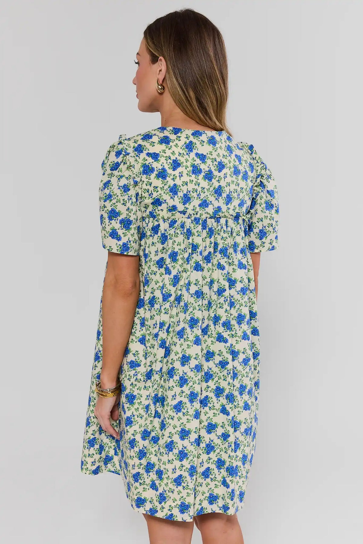 Blue Floral Pleated Short Dress back view showing puff sleeves and pleated skirt | Avara