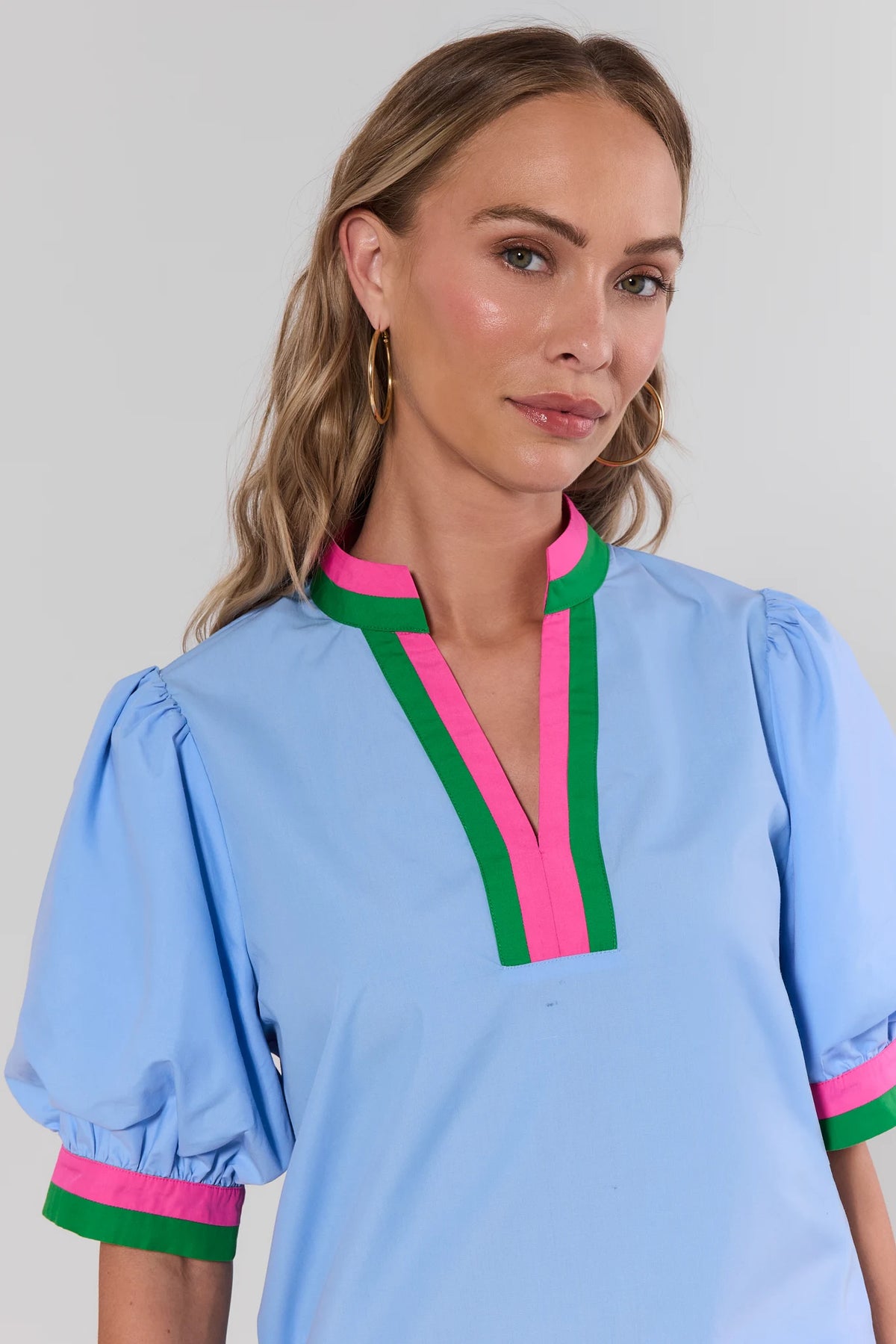 Adelaide Blue Puff Sleeve Top close-up showing pink and green contrast V-neckline and striped cuff detail | Avara