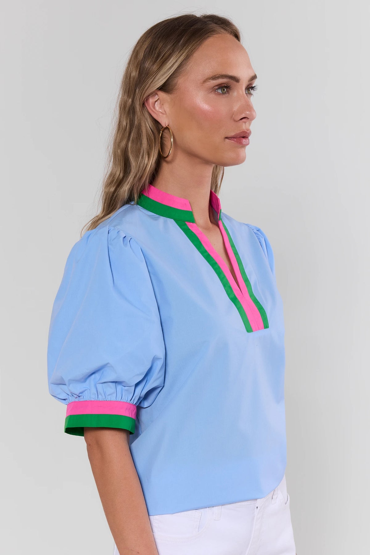 Adelaide Blue Puff Sleeve Top side profile view showing pink and green contrast collar and cuff trim | Avara
