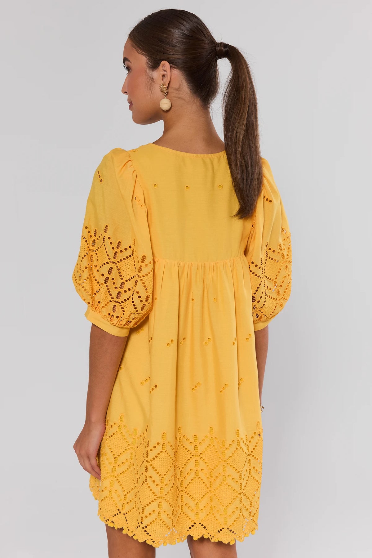 Yellow Eyelet Short Dress with scalloped eyelet hem detail - Back View On Model | Avara