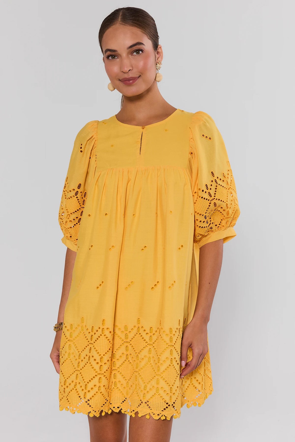 Yellow Eyelet Short Dress with puff sleeves and scalloped hem - Front View On Model | Avara
