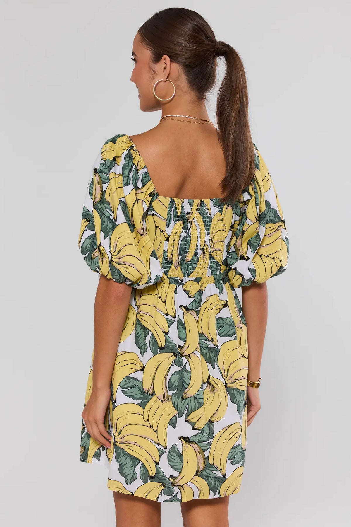 Yellow banana print dress - Back View showing smocked back detail and open neckline | Avara