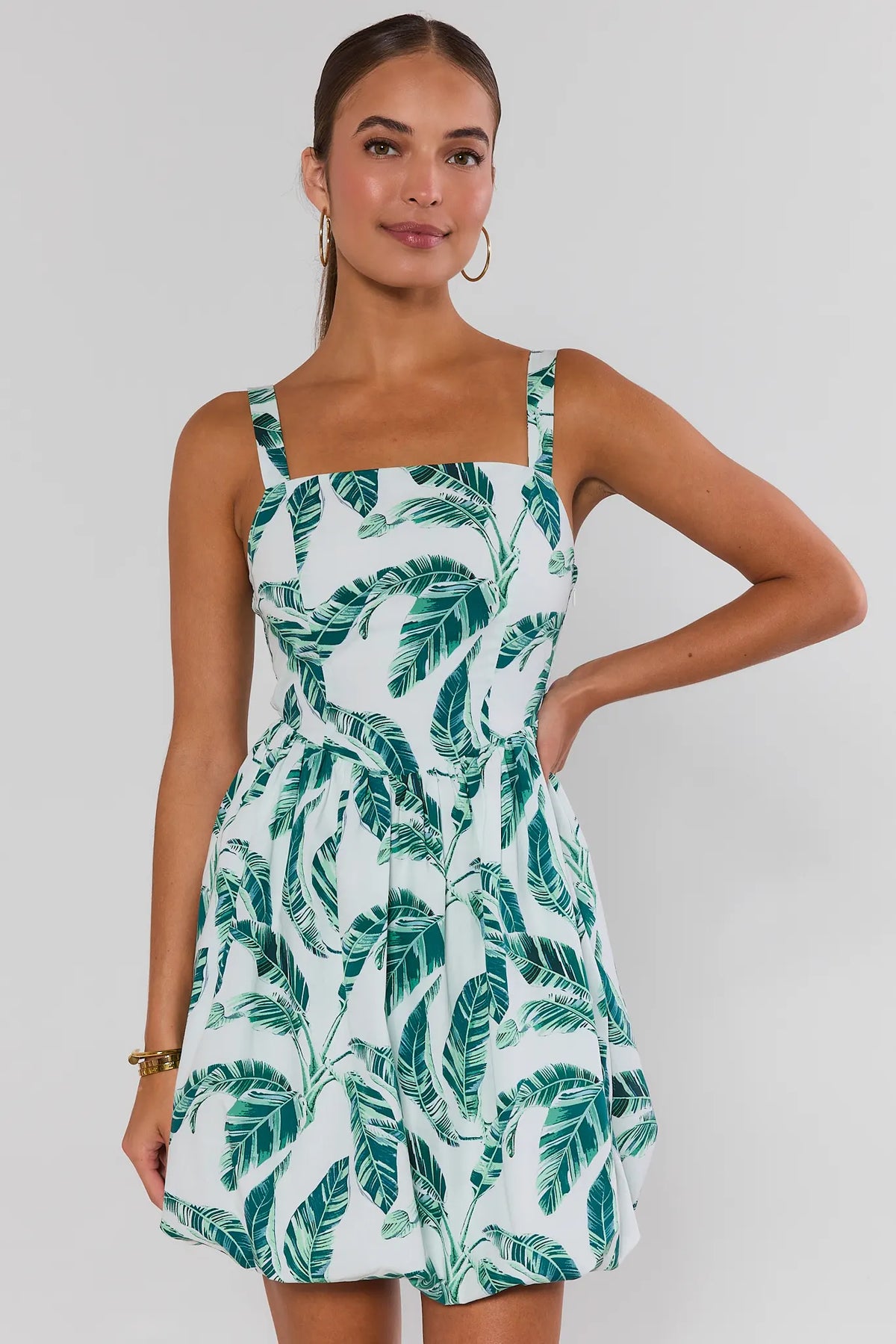 Woman wearing white green palm print bubble short dress, square neckline, front view | Avara