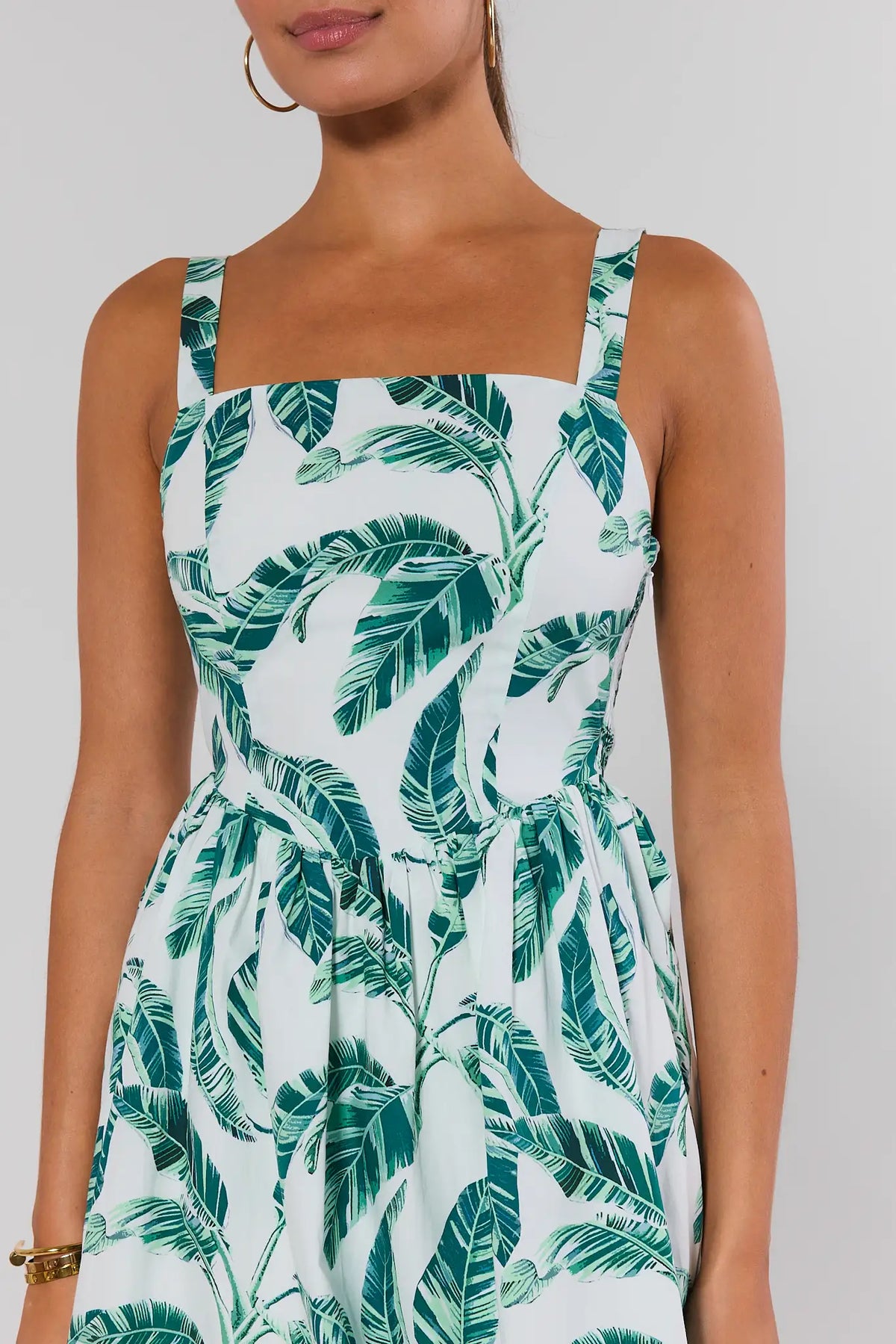 White palm print bubble short dress close-up, square neckline and smocked waist detail | Avara