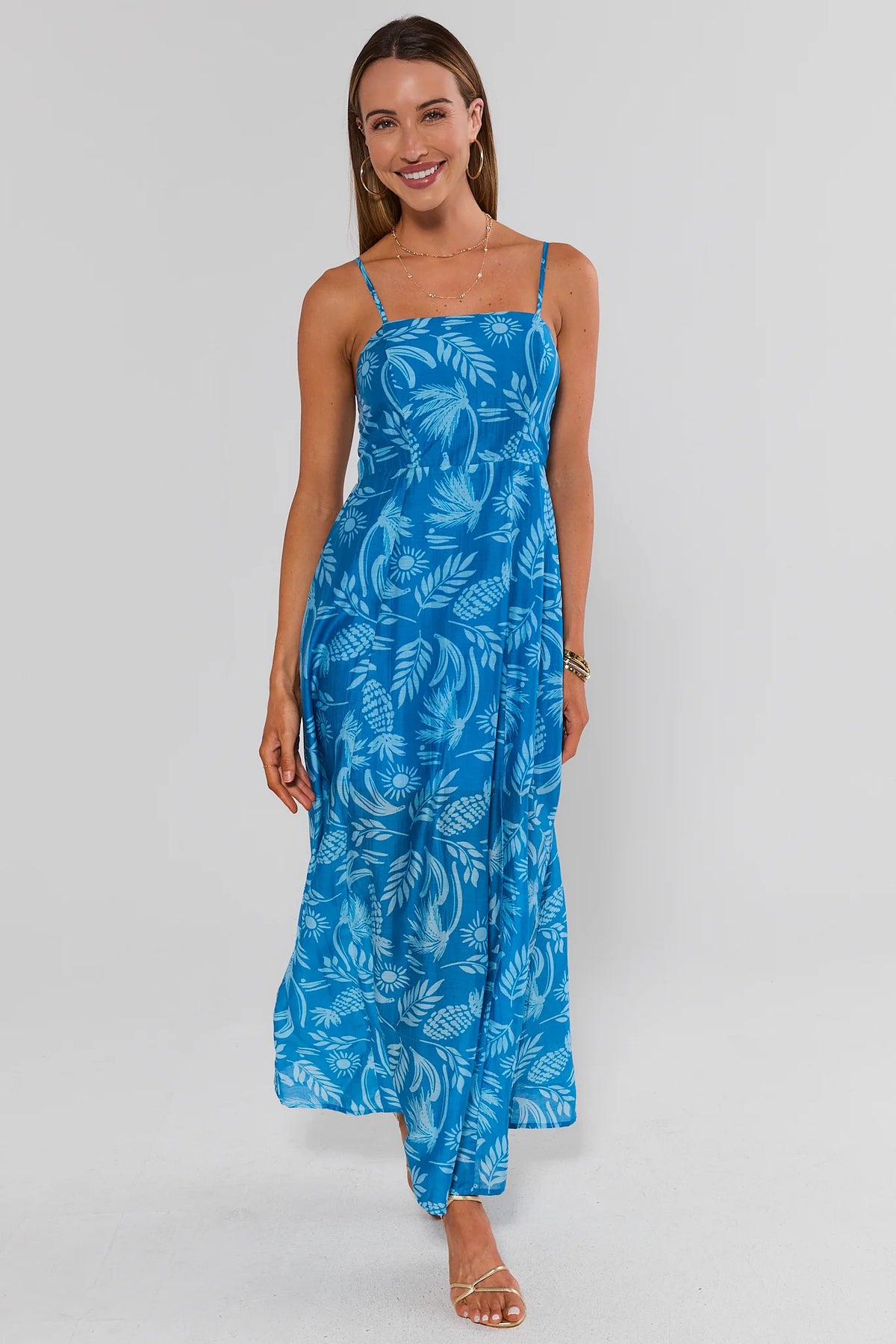 Woman wearing blue palm print midi dress with spaghetti straps, full-length front view | Avara