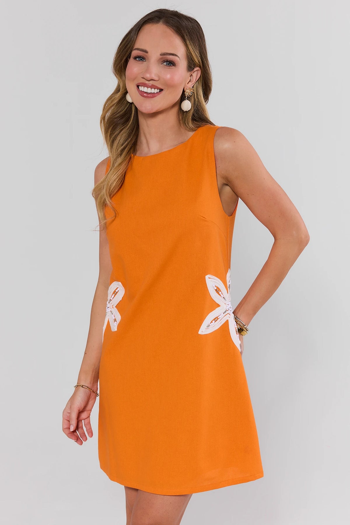 Orange Floral Embroidered Short Dress with white beaded flowers, angled front view on model | Avara