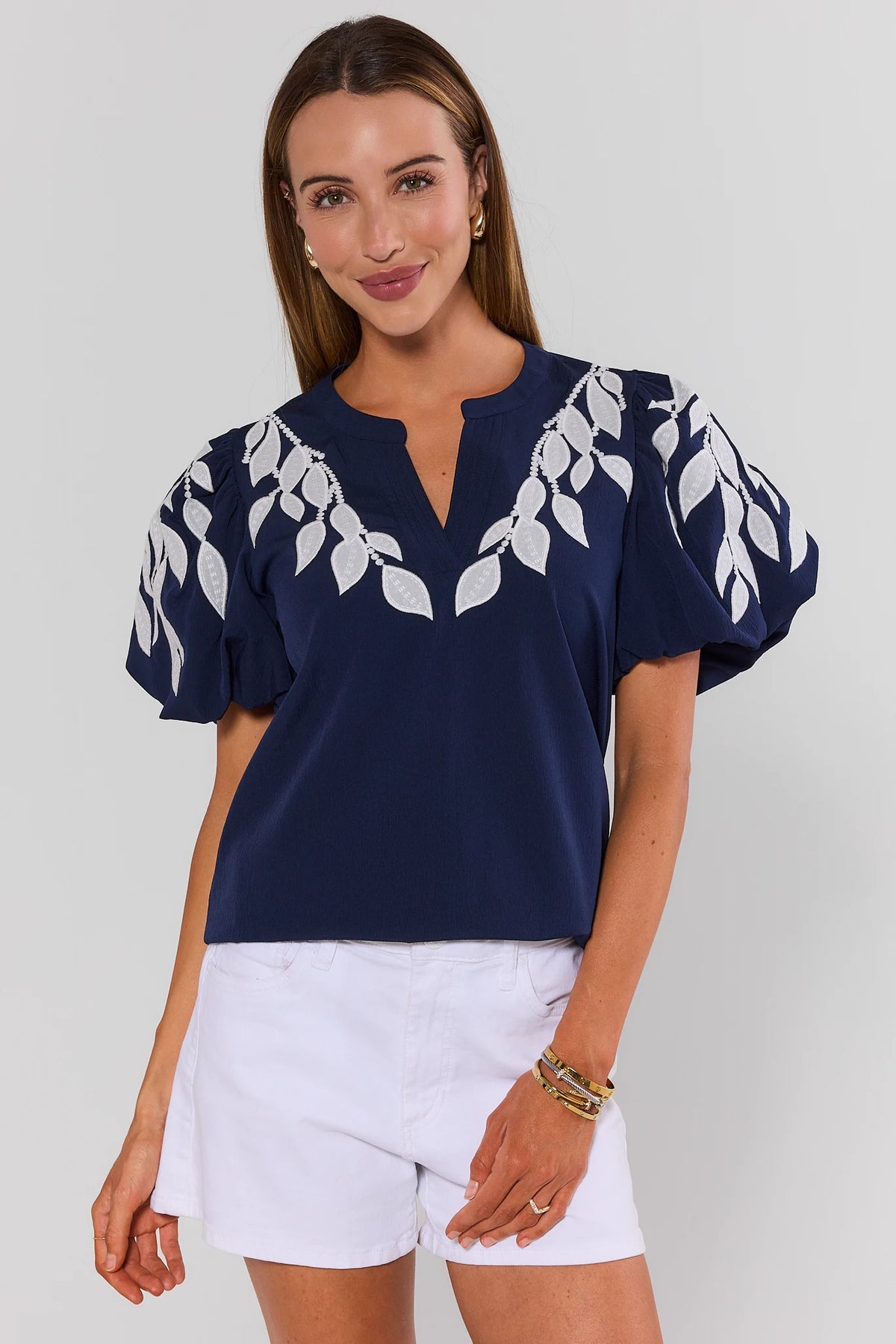 Beth Navy Embroidered Top with white leaf embroidery and puff sleeves, front view styled with white shorts | Avara