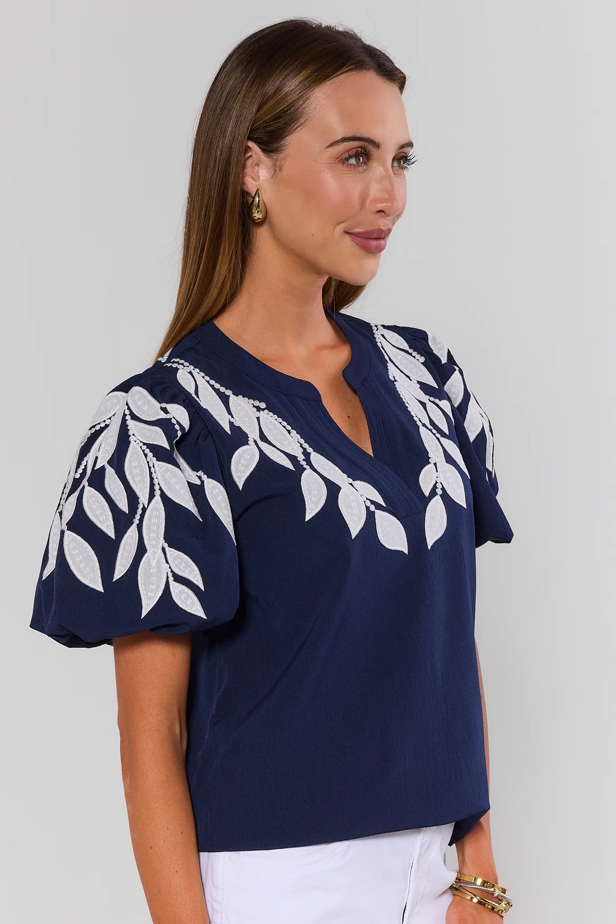 Beth Navy Embroidered Top side profile showing white leaf embroidery detail on puff sleeves and relaxed fit | Avara