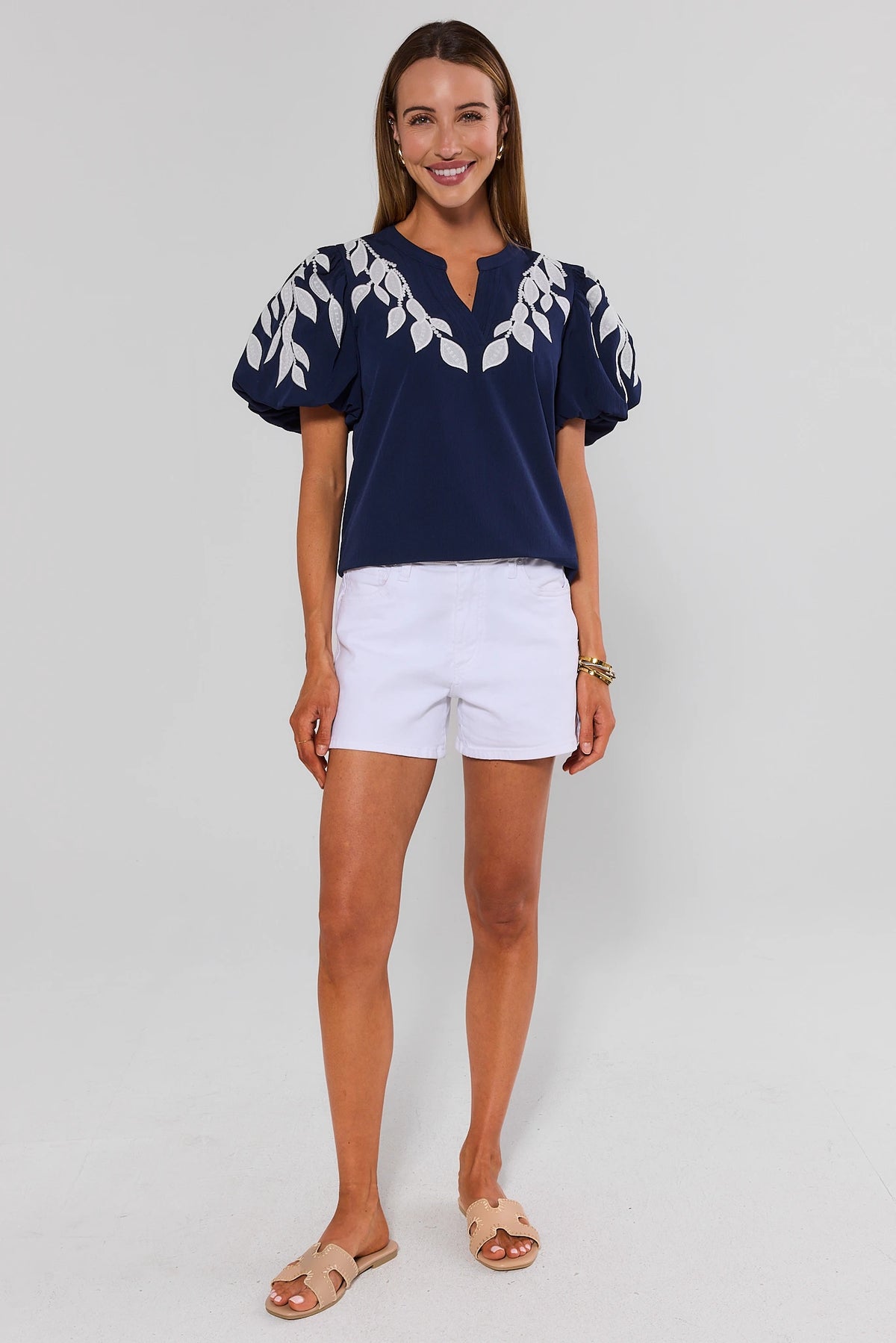 Beth Navy Embroidered Top full-length front view, cute women's top with puff sleeves styled with white shorts | Avara