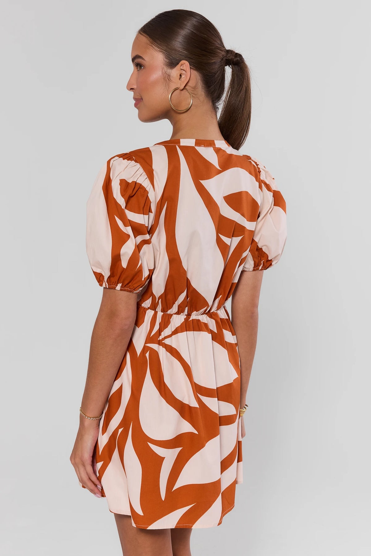 Antonia Orange Printed Short Dress showing elastic waist and puff sleeve detail - Back View | Avara