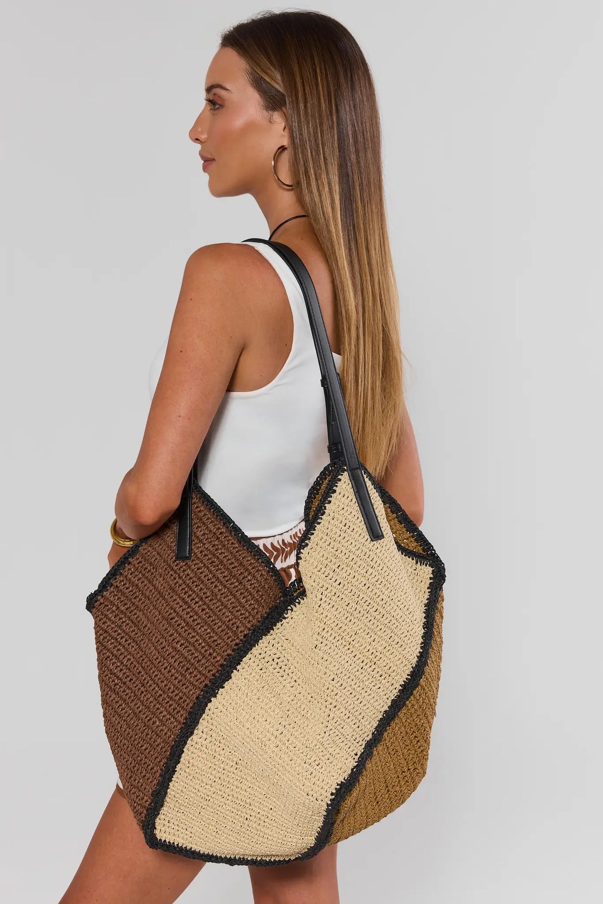 Woman carrying brown woven tote bag over shoulder - On Model Side View | Avara