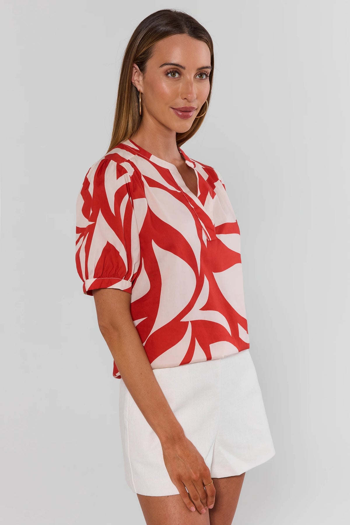 Jess Red Printed Puff Sleeve Top with white shorts, side profile view showing relaxed silhouette | Avara