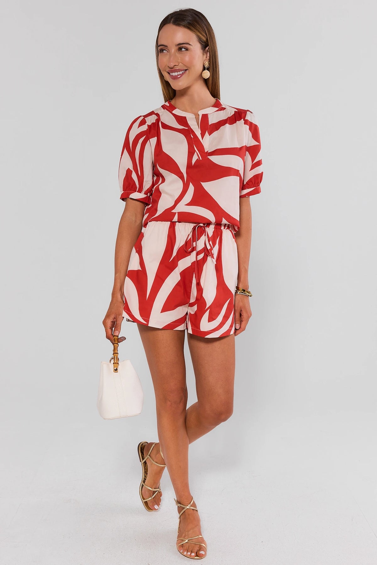 Red abstract print puff sleeve top styled with matching drawstring shorts, full outfit view on model | Avara