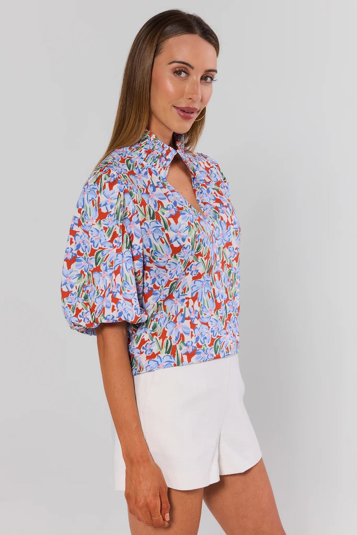 Melanie Printed Puff Sleeve Top orange & blue floral - Side View with white shorts | Avara